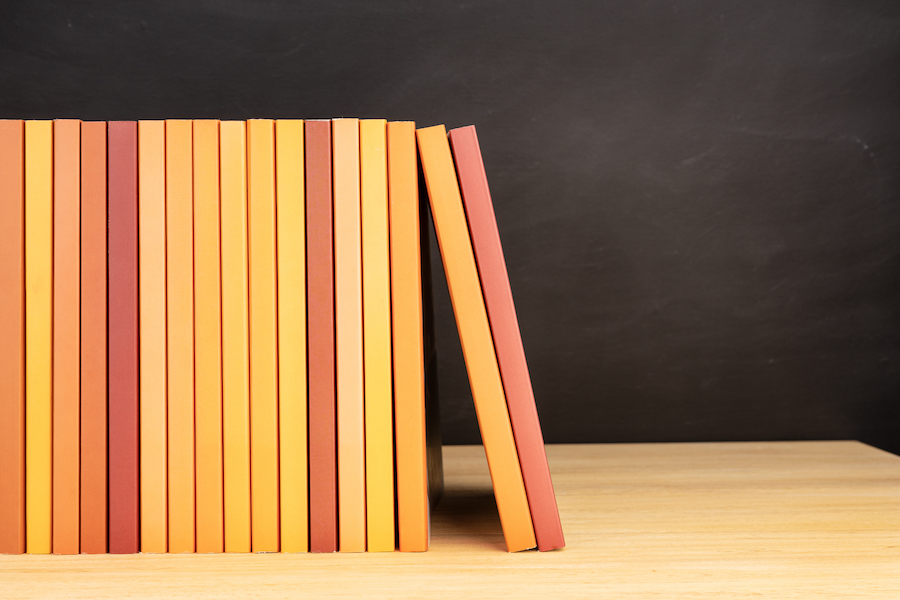 group-of-orange-books-on-wooden-table-2021-09-04-03-51-09-utc.jpg